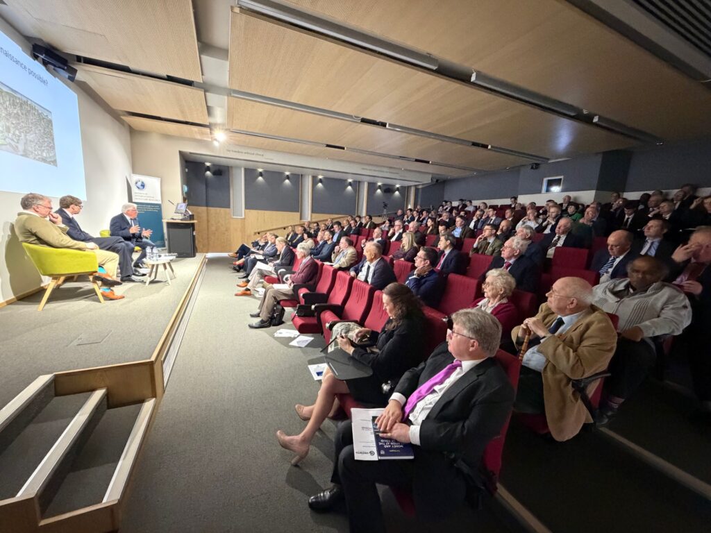 Growth Commissioners Douglas McWilliams and Ewen Stewart alongside Andrew Lilico on stage at our conference at the University of Buckingham in March 2026
